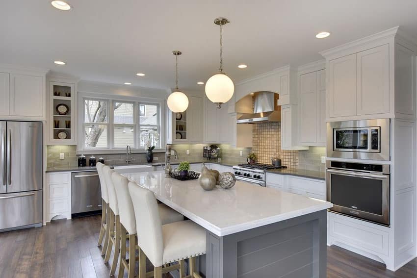 Beautiful kitchen with medium gray cabinet breakfast bar island and white shaker cabinets