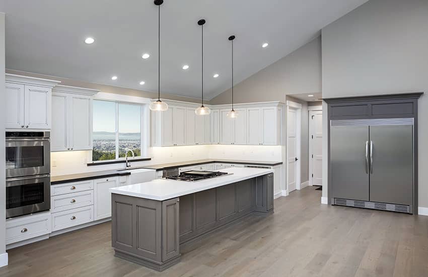 Gray-and-white kitchen with large island and vaulted ceiling
