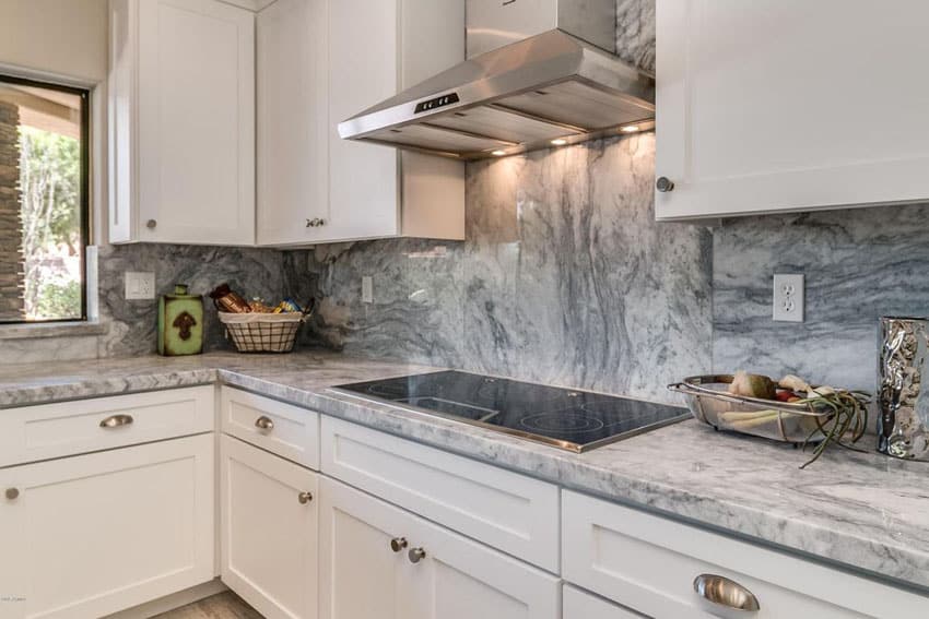 Kitchen with arabescus white marble counters with gray streaks 