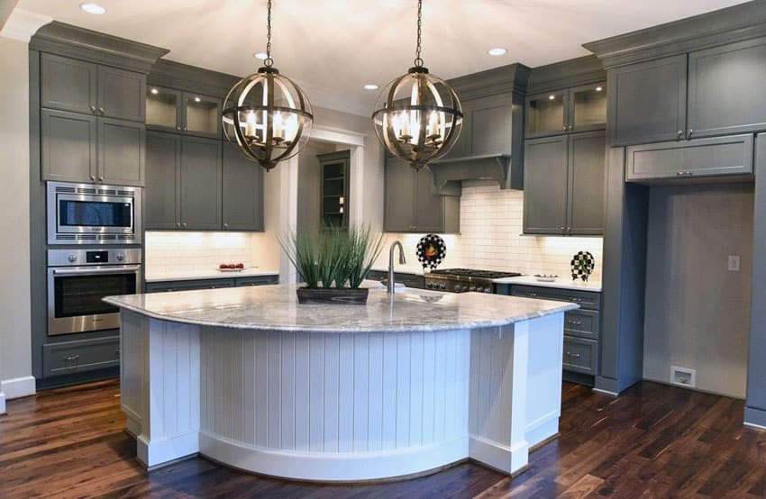 Kitchen with globe pendant lights and fluted island cabinet
