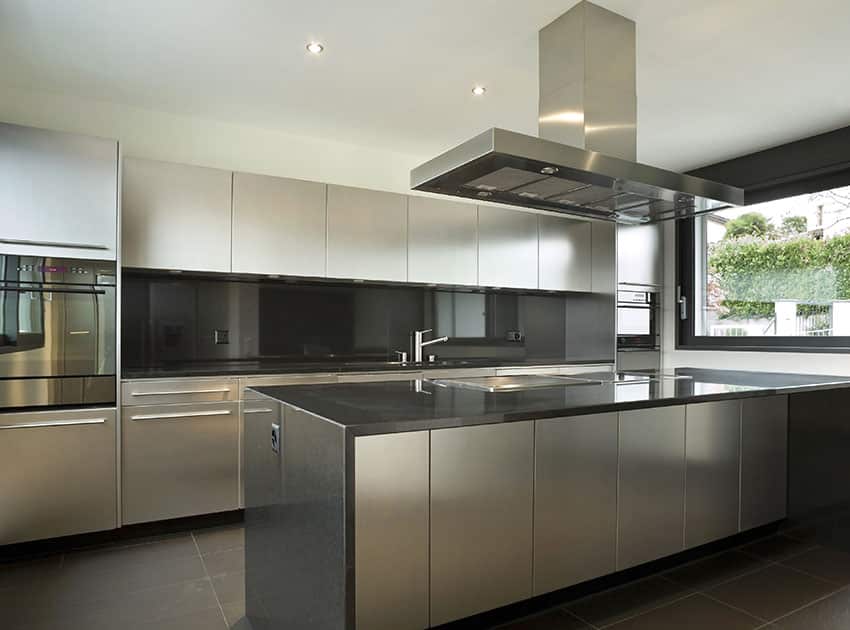kitchen with range hood over island and light grey cupboards