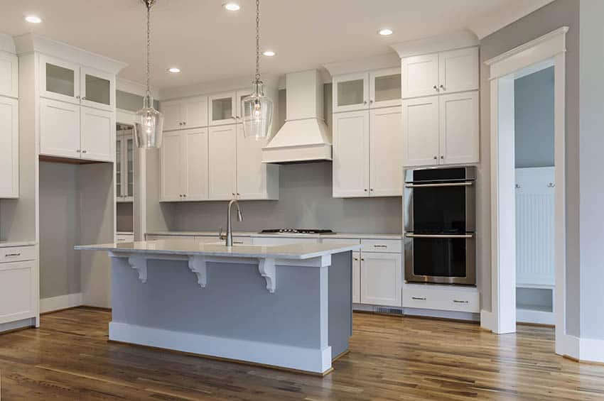 Traditional plan kitchen with shaker style cabinets and light hued island